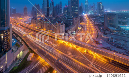 Dubai downtown skyline night to day aerial timelapse with traffic on highway Dubai downtown skyline night to day aerial timelapse with traffic on highway 140891621