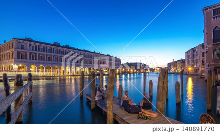 View of the deserted Rialto Market day to night timelapse after sunset, Venice, Italy viewed from pier across the Grand Canal View of the deserted Rialto Market day to night timelapse after sunset, Venice, Italy viewed from pier across the Grand Canal 140891770
