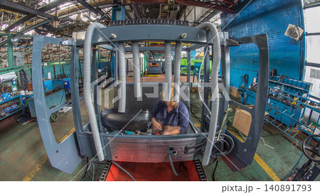 Conveyor assembly stage the body of tractor at big industrial factory timelapse Conveyor assembly stage the body of tractor at big industrial factory timelapse 140891793