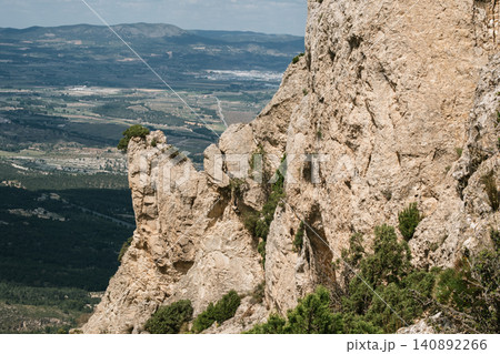 Rugged mountain terrain with panoramic valley views and majestic rocky cliffs Rugged mountain terrain with panoramic valley views and majestic rocky cliffs 140892266
