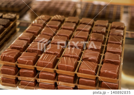 Delicious assortment of milk chocolate cubes on display in a sweet shop Delicious assortment of milk chocolate cubes on display in a sweet shop 140892835