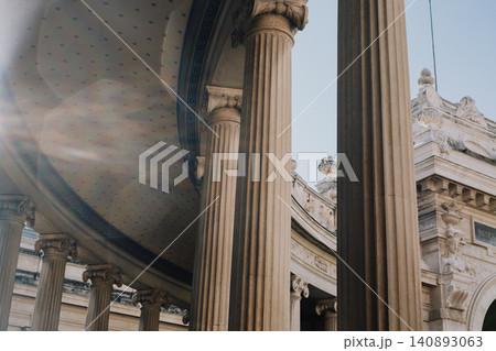 Majestic architectural columns with sunlight streaming through historic structure 140893063