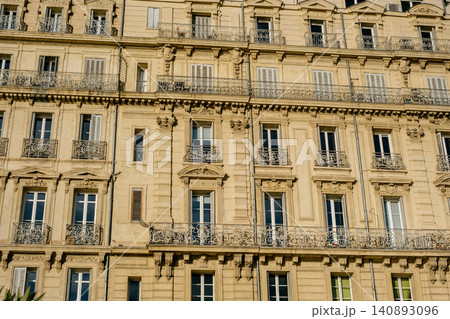 Charming parisian architecture with classic balconies and ornate facades in warm afternoon light Charming parisian architecture with classic balconies and ornate facades in warm afternoon light 140893096