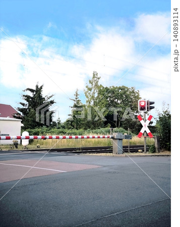 Closed railway crossing with a red traffic light signal Closed railway crossing with a red traffic light signal 140893114