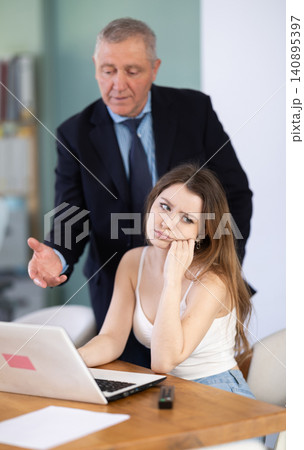 Boss scolding at office employee 140895397