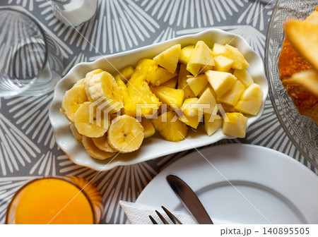 Healthy food - sliced bananas and pineapples on a plate Healthy food - sliced bananas and pineapples on a plate 140895505