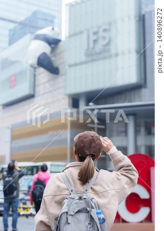 woman traveler travel in Chengdu city. Happy Tourist sightseeing in Chunxi Road, located in the Jinjiang District. Famous landmark for tourism attraction in Sichuan, China woman traveler travel in Chengdu city. Happy Tourist sightseeing in Chunxi Road, located in the Jinjiang District. Famous landmark for tourism attraction in Sichuan, China 140896272