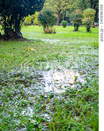 Park after the rain. Park lawn in puddles. After bad weather. Autumn in the park. Park after the rain. Park lawn in puddles. After bad weather. Autumn in the park. 140896308