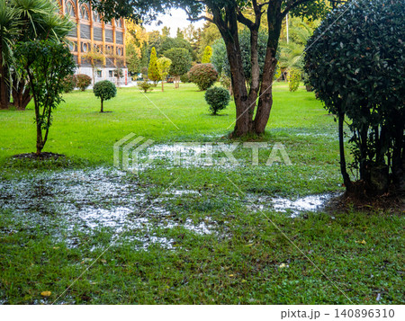 Park after the rain. Park lawn in puddles. After bad weather. Autumn in the park. Park after the rain. Park lawn in puddles. After bad weather. Autumn in the park. 140896310