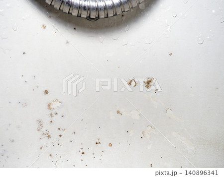 Mold on the surface of the bathroom. Dark mold close-up on bathroom enamel. Dirty white surface. Mold on the surface of the bathroom. Dark mold close-up on bathroom enamel. Dirty white surface. 140896341