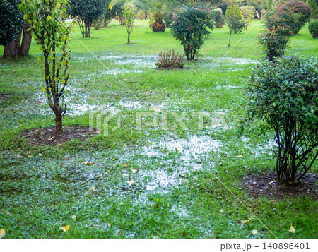 Park after the rain. Park lawn in puddles. After bad weather. Autumn in the park. Park after the rain. Park lawn in puddles. After bad weather. Autumn in the park. 140896401