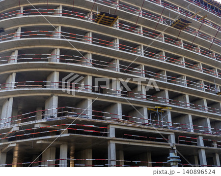 Construction of a modern high-rise building. Sides on the floors. Concrete frame of a building under construction. Construction in progress Construction of a modern high-rise building. Sides on the floors. Concrete frame of a building under construction. Construction in progress 140896524