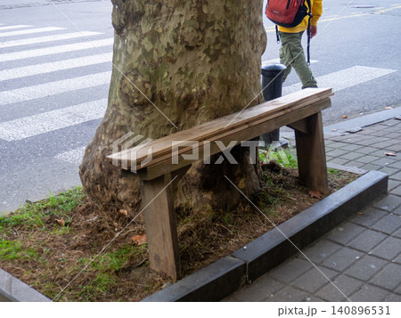 A rickety bench on the street. Seat for people. Poor infrastructure. A rickety bench on the street. Seat for people. Poor infrastructure. 140896531