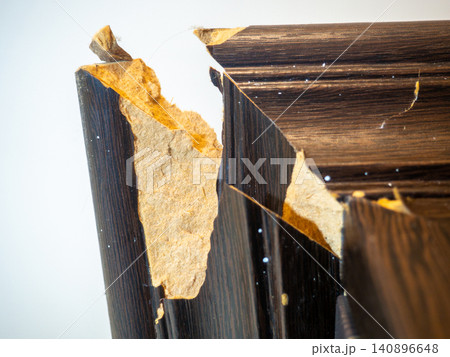 corner of the cabinet is broken. Crack in a wooden cabinet. Breakage when carrying furniture. Needs restoration. corner of the cabinet is broken. Crack in a wooden cabinet. Breakage when carrying furniture. Needs restoration. 140896648
