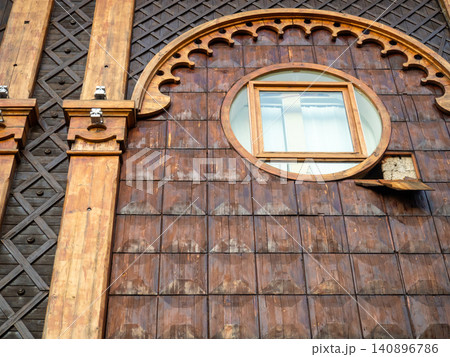 Windows in a wooden theater. Facade of a beautiful building. Georgian theatre. Windows in a wooden theater. Facade of a beautiful building. Georgian theatre. 140896786