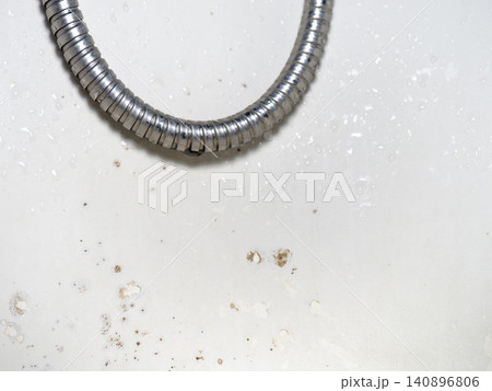 Mold on the surface of the bathroom. Dark mold close-up on bathroom enamel. The concept of the appearance of bacteria. Shower hose Mold on the surface of the bathroom. Dark mold close-up on bathroom enamel. The concept of the appearance of bacteria. Shower hose 140896806