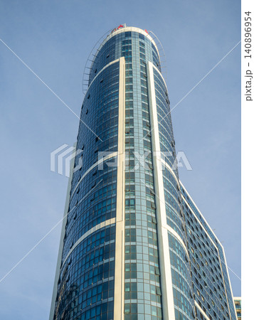 Glass facade of a house under construction with open windows. Windows opening outwards. Geometry in architecture. Glass facade of a house under construction with open windows. Windows opening outwards. Geometry in architecture. 140896954