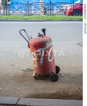 Gas cylinder for refueling cars. Refueling. Gas cylinder in the city. Gas cylinder for refueling cars. Refueling. Gas cylinder in the city. 140896965