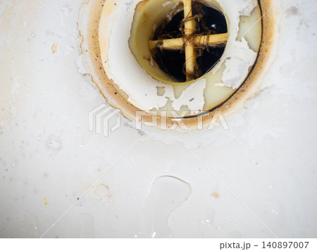 Clogged and dirty drain in the bathroom. Black dots on bathroom enamel. Mold in the bathroom. Need a cleaning product. Cleaning product concept Clogged and dirty drain in the bathroom. Black dots on bathroom enamel. Mold in the bathroom. Need a cleaning product. Cleaning product concept 140897007
