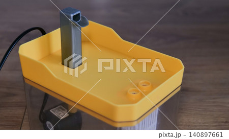 Yellow Cat Drinking Fountain with Flowing Water 140897661