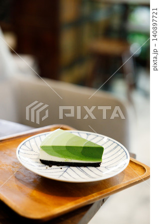 Green tea cake pie with gradient layered in cafe. Green tea cake pie with gradient layered in cafe. 140897721
