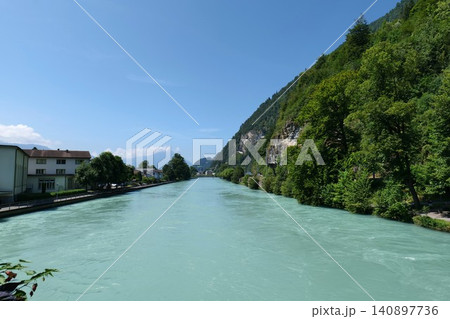 Scenic Turquoise River in a Mountain Valley with a Town. switzerland 140897736