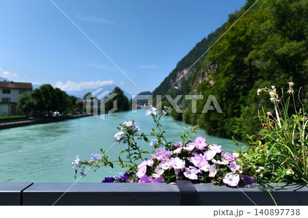 Scenic Mountain River with Blooming Flowers on a Sunny Day. switzerland 140897738