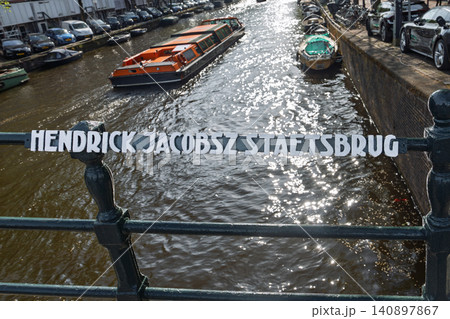 Hendrick Jacobsz Staetsbrug bridge sign over a canal in Amsterdam, Netherlands city scene 140897867