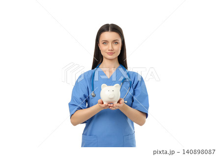 Person in blue scrubs holds a piggy bank, isolated, PNG 140898087