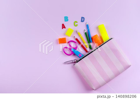 Colorful school supplies spilling from pink zipper pouch Colorful school supplies spilling from pink zipper pouch 140898206