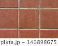 Red terracotta floor tiles forming a geometric pattern 140898675