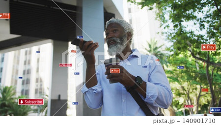 Speaking into phone, blue-shirt man holding coffee beneath overhang on street, showing AR badges 140901710