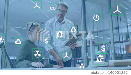 Pointing, man in checked shirt and woman in sweater reviewing drone at desk, with AR icons Pointing, man in checked shirt and woman in sweater reviewing drone at desk, with AR icons 140901852