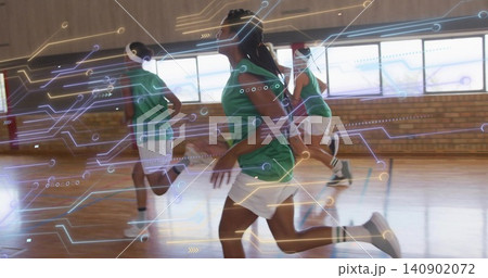 Sprinting female athlete wearing green jersey and white shorts across gym court, circuit overlay 140902072