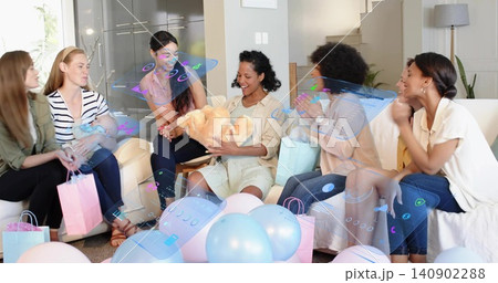 Clapping group of friends in living room, holding teddy and swaddled baby, with balloons and AR Clapping group of friends in living room, holding teddy and swaddled baby, with balloons and AR 140902288