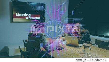 Discussing project at meeting table, three team wearing business attire pointing at laptop hologram 140902444
