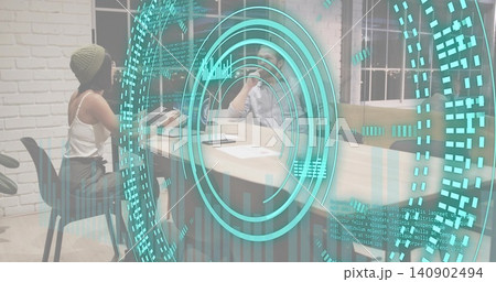 Projecting cyan AR circular interface hovering over office meeting table, beanie woman gesturing Projecting cyan AR circular interface hovering over office meeting table, beanie woman gesturing 140902494