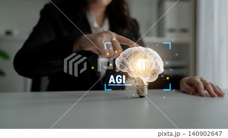 Business Professional Interacting with Conceptual Light Bulb Brain Representing Advanced Artificial General Intelligence in Modern Office Environment Haptic Business Professional Interacting with Conceptual Light Bulb Brain Representing Advanced Artificial General Intelligence in Modern Office Environment Haptic 140902647