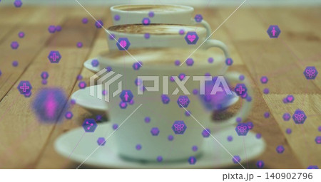 Displaying three white ceramic cups with crema on saucers sitting on wood table, purple hex icons Displaying three white ceramic cups with crema on saucers sitting on wood table, purple hex icons 140902796