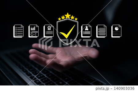 Digital business security concept with icons representing trust, certification, and compliance above a hand on a laptop keyboard in a dark setting. Glyphic 140903036