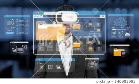 A smartly dressed businessman using virtual reality technology, showcasing digital file interfaces and intricate data management visuals in a modern workspace setting. Sigmoid 140903083