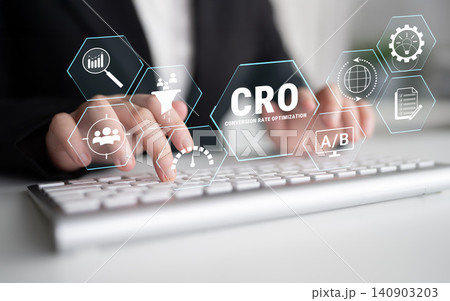 Hands Typing on Keyboard with Graphs and Icons Representing Conversion Rate Optimization Strategies for Digital Marketing Success. Glyphic 140903203