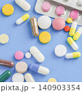 Seamless pattern of colorful medical pills capsules and tablets flat lay on blue background 140903354