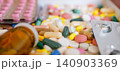 Wide horizontal composition of pharmaceutical capsules, colorful tablets, and blister packs with glass bottle 140903369