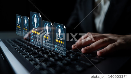 A professional examines digital candidate profiles on a laptop, emphasizing modern recruitment strategies and data-driven evaluations in the hiring process. Sigmoid 140903374
