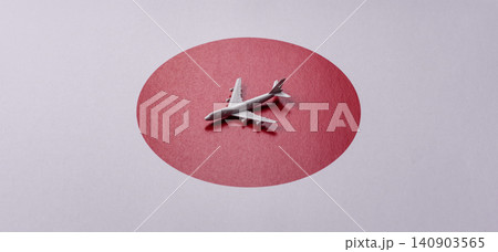 An airplane on the japanese flag as a conceptual backdrop. An airplane on the japanese flag An airplane on the japanese flag as a conceptual backdrop. An airplane on the japanese flag 140903565