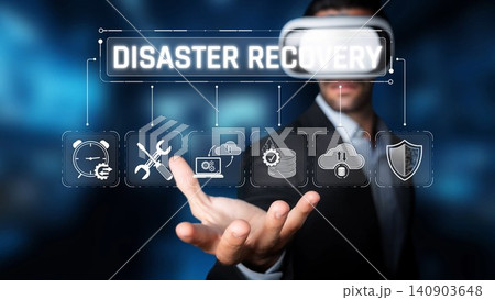 A businessman engages with virtual reality technology illustrating disaster recovery solutions, emphasizing strategic planning and modern digital resource management. Sigmoid A businessman engages with virtual reality technology illustrating disaster recovery solutions, emphasizing strategic planning and modern digital resource management. Sigmoid 140903648