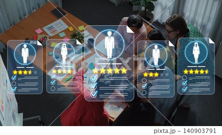 A group of professionals engages in teamwork, analyzing digital profiles with ratings and feedback to enhance performance in a modern office environment. Sigmoid 140903791