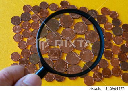 Magnifying Glass Examining Small Euro Cent Coins and Future of Low Value Currency in Europe Today Magnifying Glass Examining Small Euro Cent Coins and Future of Low Value Currency in Europe Today 140904373