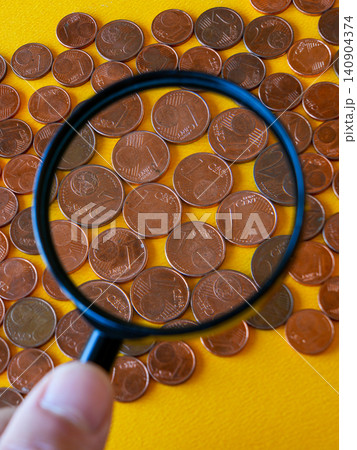 Magnifying Glass Highlighting Small Euro Cent Coins and Their Role in Modern Cash Payments Today Magnifying Glass Highlighting Small Euro Cent Coins and Their Role in Modern Cash Payments Today 140904374